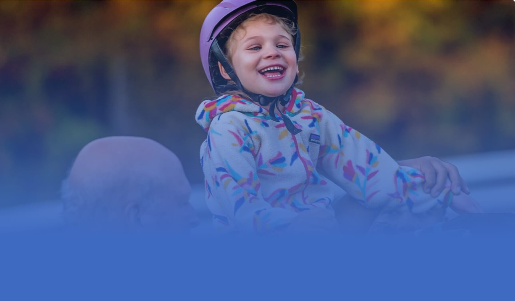 Child riding horse smiling